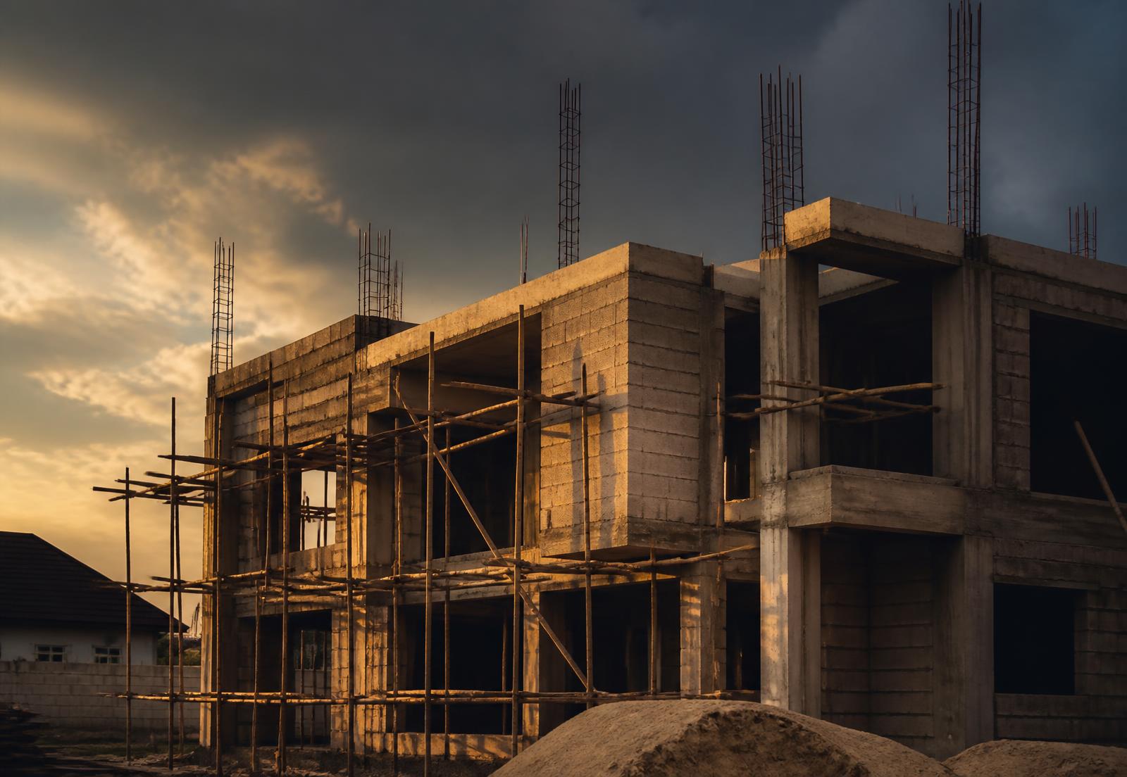 Partially completed residential building under construction in Nigeria at golden hour
